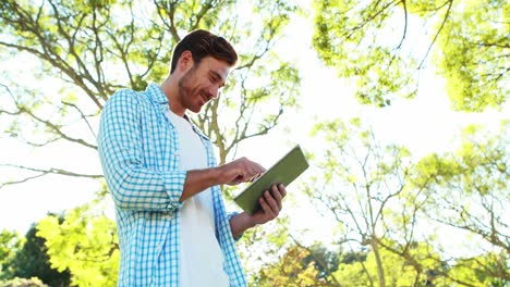 Man-using-digital-tablet-in-park