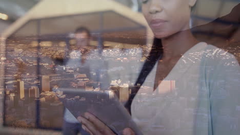 using tablet, businesswoman viewing animation of cityscape in modern office