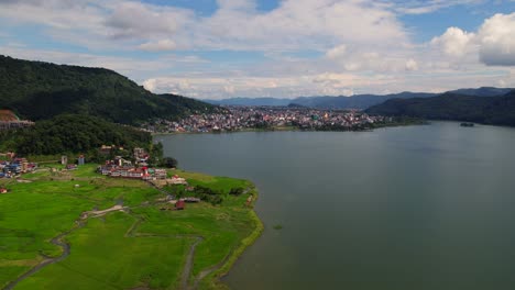 beautiful aerial view of phewa lake and pokhara city with clear sky and mountain peak background, nepal