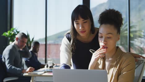 two women using computer at the office