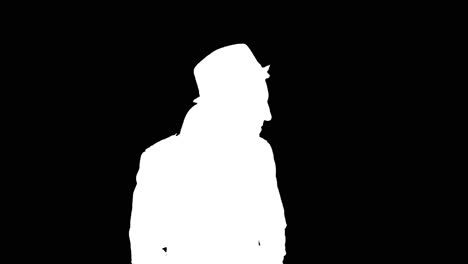 man in long coat puts on hat, white silhouette on black background