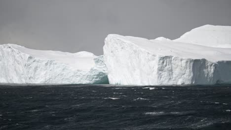 gigantic ice berg with water in foreground