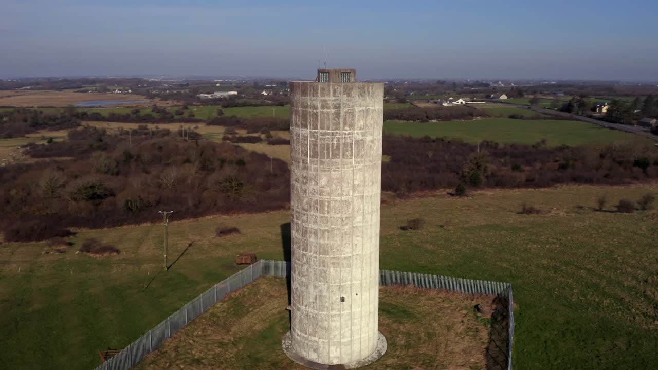 Aerial shot of a large water tower in Clarinbridge, Galway, bathed in the soft light of the morning sunshine.