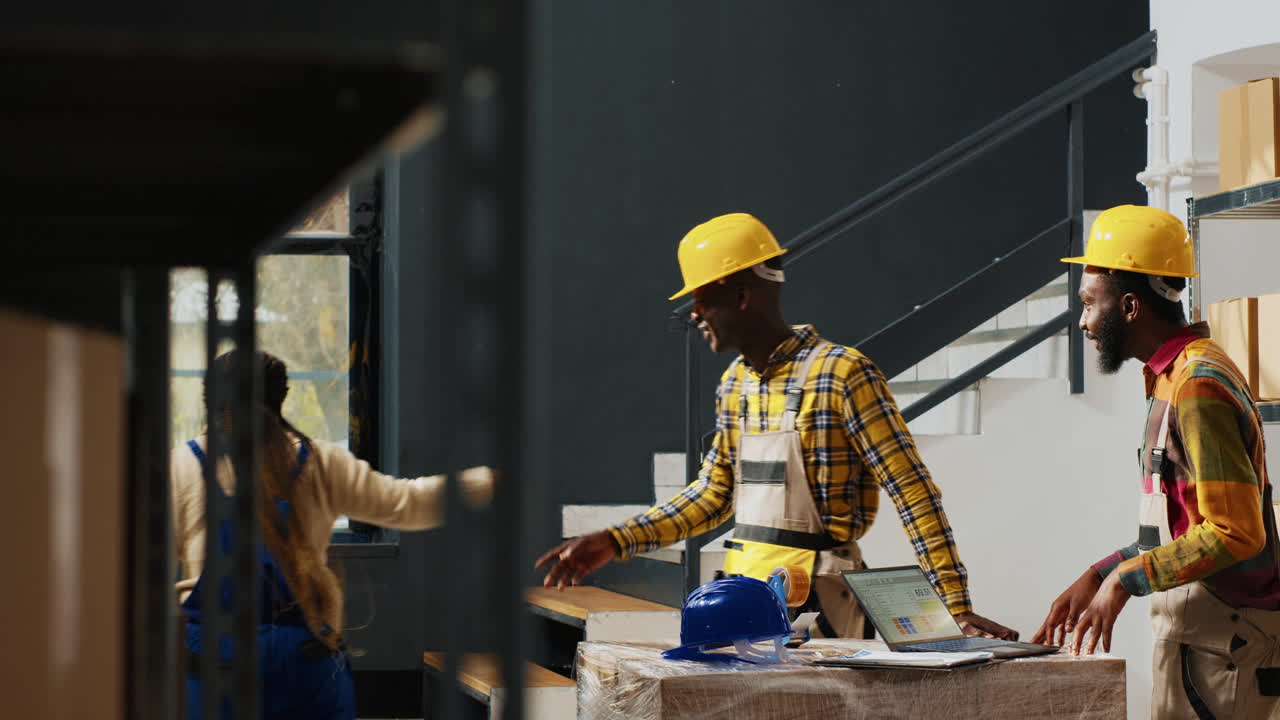 Warehouse workers discussing inventory