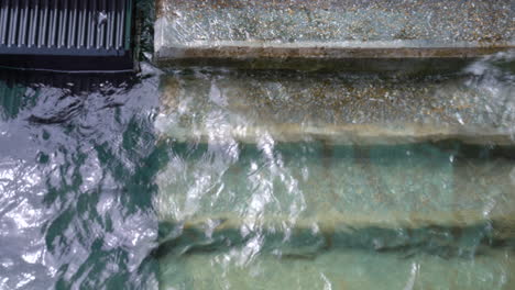 water crashing on the stairs in a lake during a cloudy day