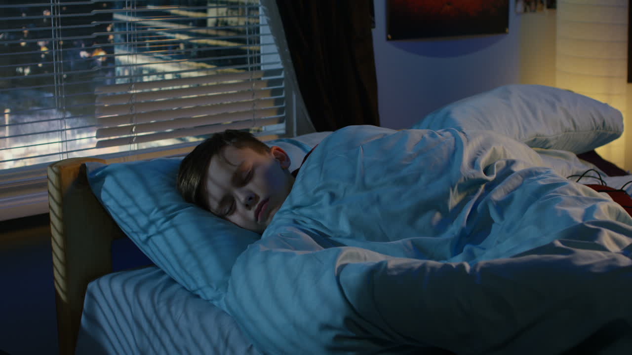 Teenage Boy Sleeping in His Room at Night