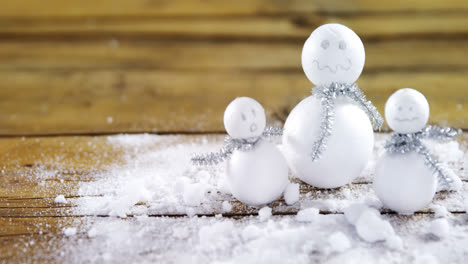 handmade snowman on wooden table 4k