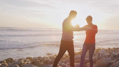 couple dancing by the sea