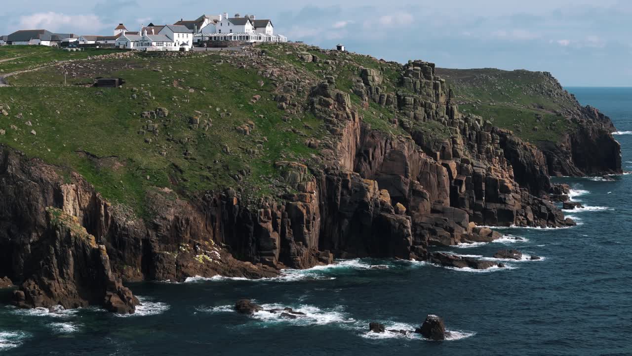 Aerial circle around Land’s End visitor centre as waves crash below