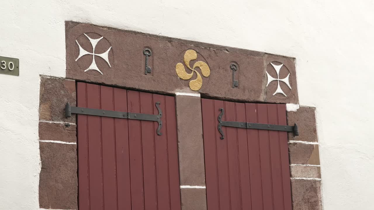 Lauburu symbole, a basque symbol, carved into a stone lintel in the french town of Saint-Jean-Pied-de-Port.