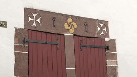 lauburu symbole, a basque symbol, carved into a stone lintel in the french town of saint-jean-pied-de-port.