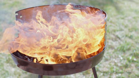 flaming charcoal briquettes in a bbq