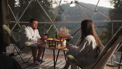 couple enjoying a romantic dinner in a geodesic dome