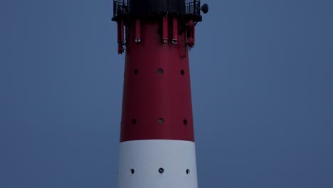 slow tilt shot of working lighthouse at night