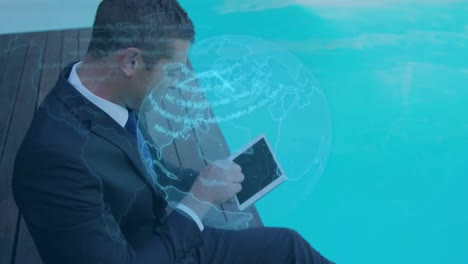 Animation-of-blue-globe-and-data-processing,-over-businessman-using-tablet-by-pool