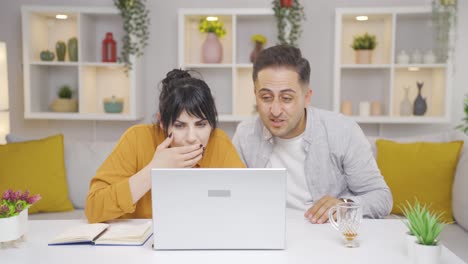 Confused-couple-looking-at-laptop.