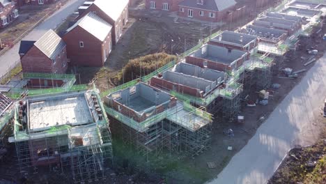 aerial view above suburban townhouse framework development construction site at sunrise