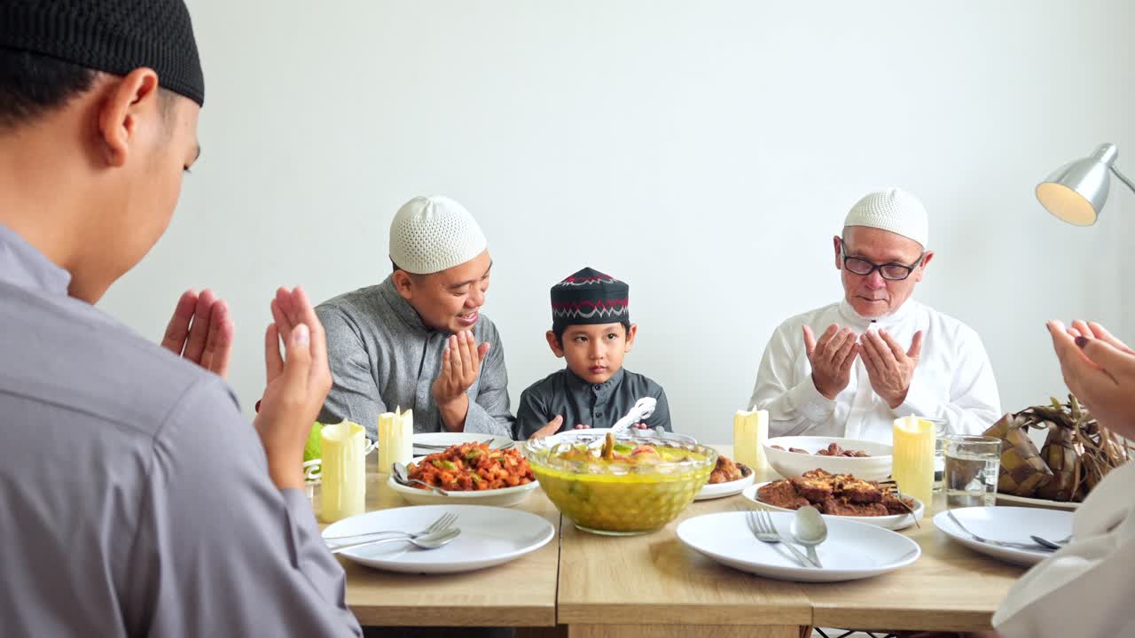 Happy Multi Generation Muslim Family Praying Together Before Having Lunch Together On Eid Moment