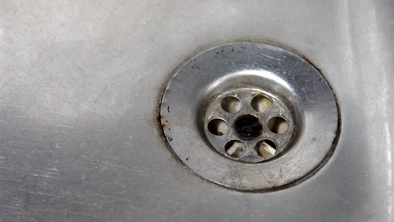 Dirty sink closeup with dripping water-drop. Water leaking, saving concept., background loop