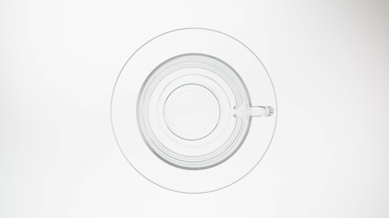 Pouring Red Tea into a Glass Cup