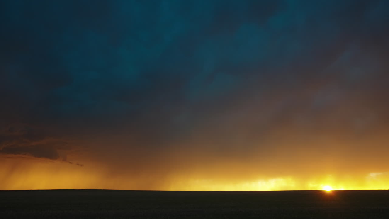 Setting Sun Rays Shine with Bright Colors Under Storm Clouds and Lightning