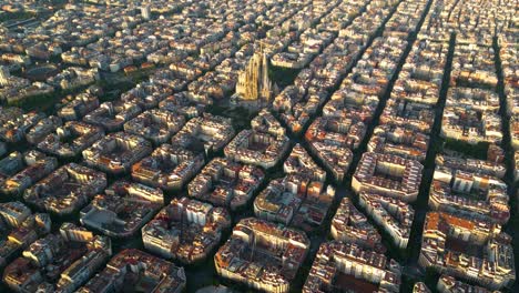 aerial view of barcelona eixample residential district and famous basilica sagrada familia at sunrise. catalonia, spain