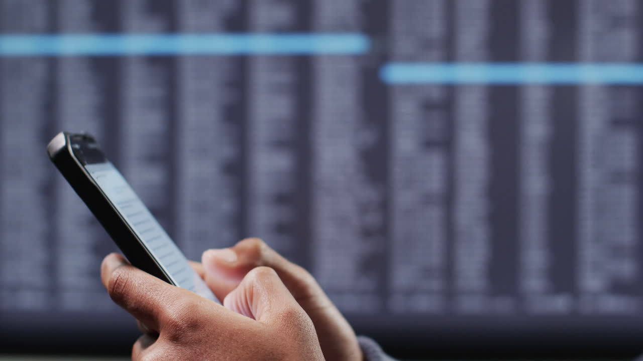 Video of biracial businessman using smartphone with data processing in background