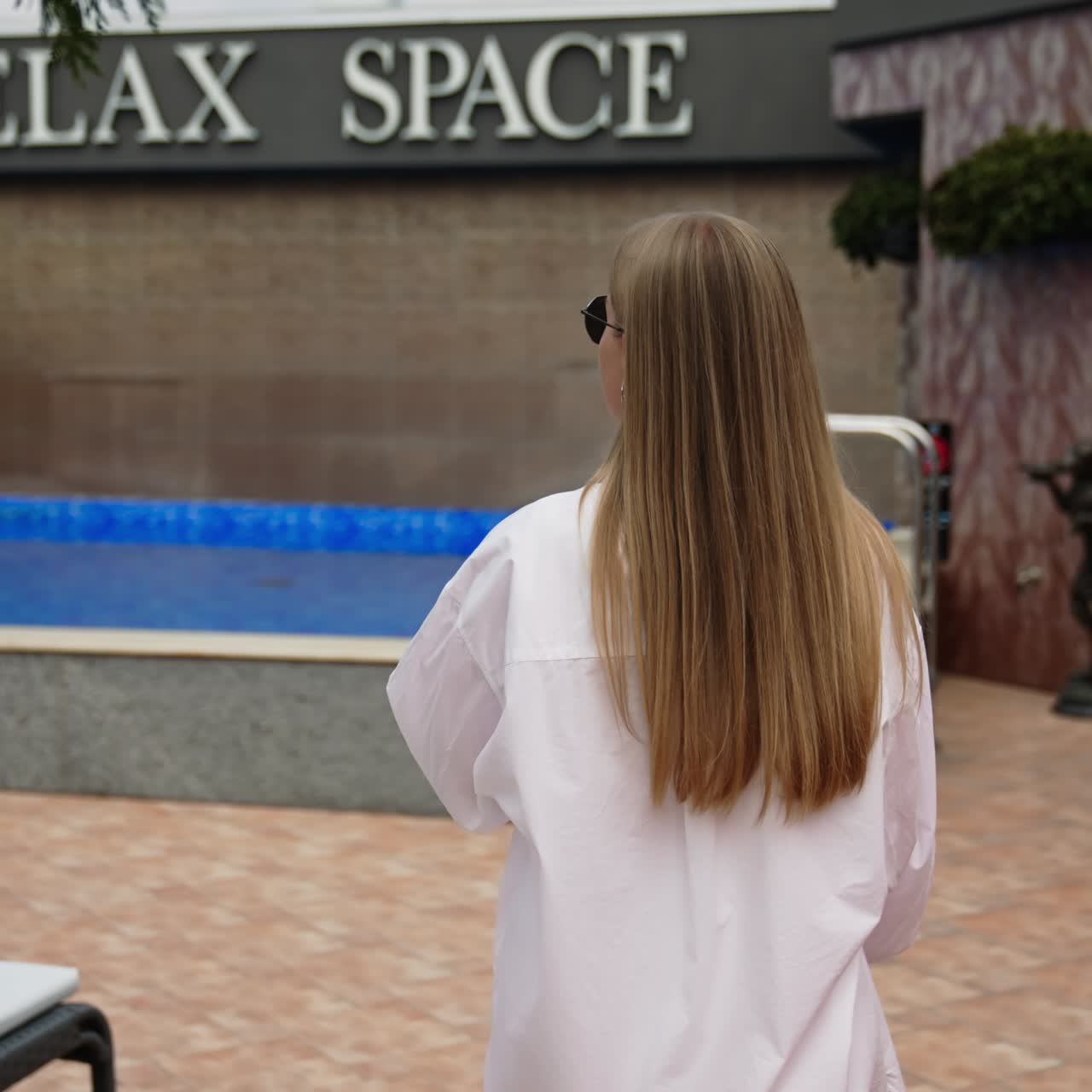 Woman in sexy swimwear relaxing near pool. Travelling and having holiday in the luxury hotel
