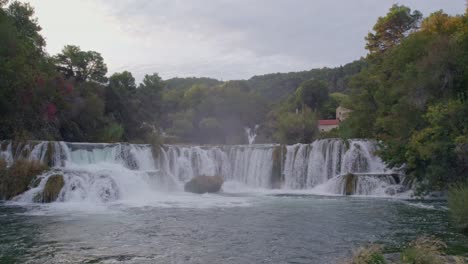 Flying-over-the-beautiful-Krka-Waterfalls-in-Krka-National-Park-during-sunrise-with-no-people,-aerial