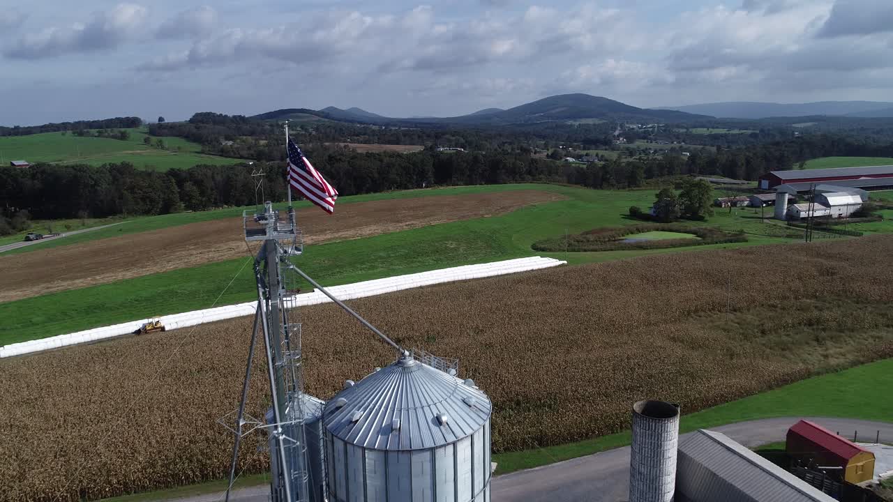 Aerial view of a farm with silos and an American flag