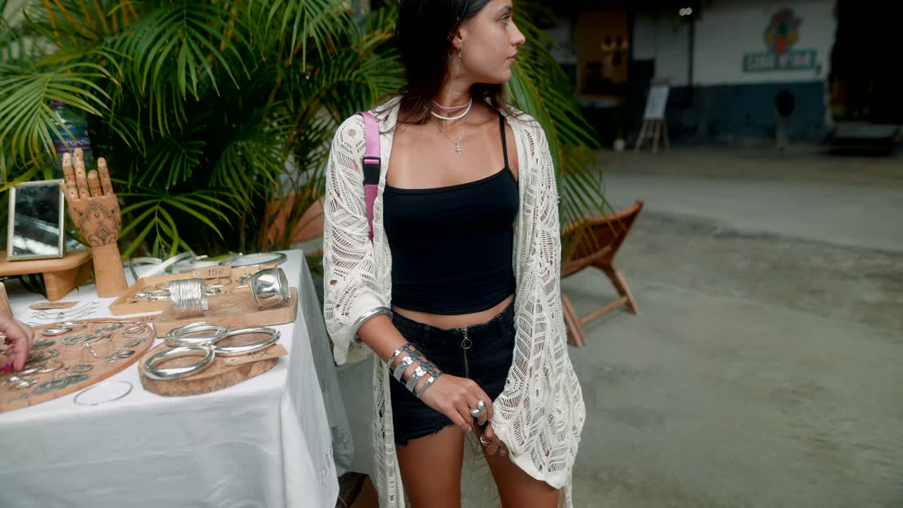 Woman Shopping for Jewelry at Outdoor Market