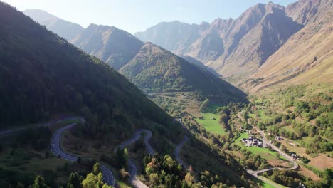 winding road in french pyrenees showcasing le plan town surrounded by mountains