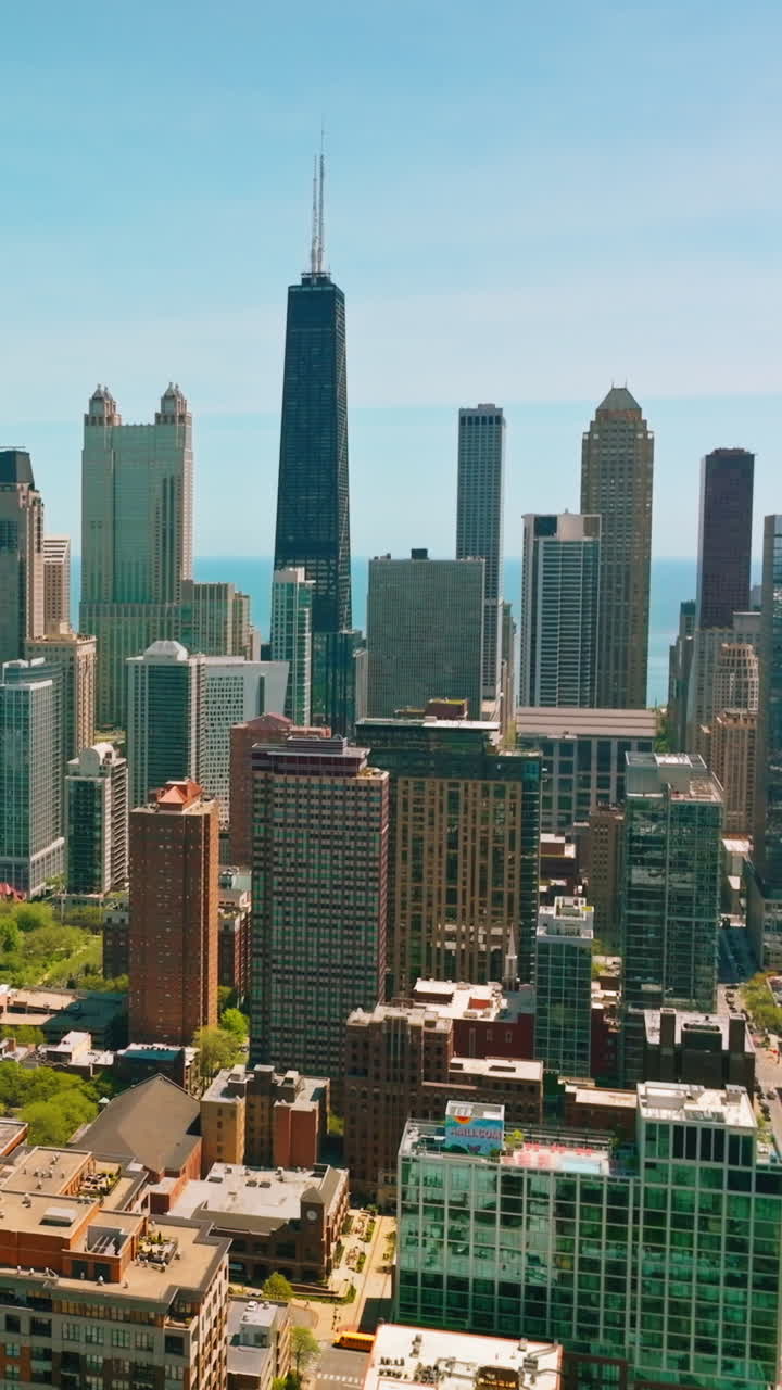 Beautiful panorama of a modern urban city. Multi- storied buildings against the backdrop of skyscrapers in the blue sky background. Vertical video
