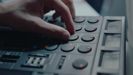 hand of musician using vintage multitrack cassette recorder