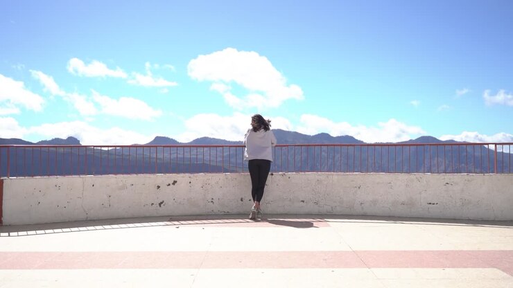 Woman looking at mountains landscape at viewpoint in Artenara, Gran Canaria, Spain