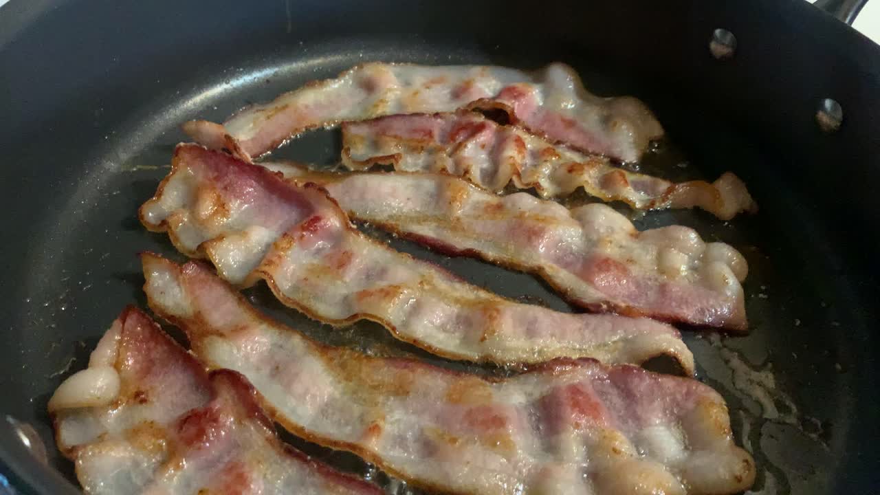 Bacon Cooking on stovetop in kitchen