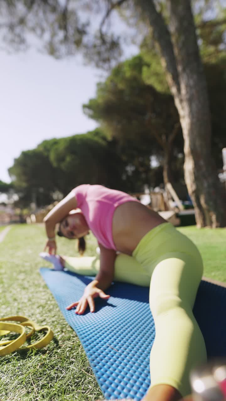 Woman Stretching and Doing Splits on a Yoga Mat Outdoors