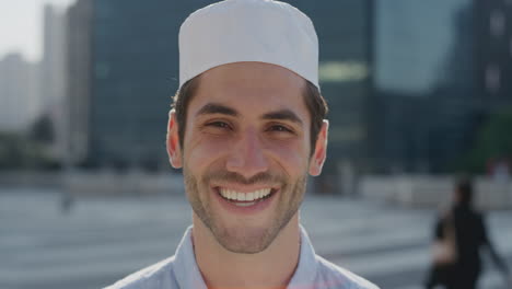 portrait-attractive-young-arab-businessman-smiling-happy-entrepreneur-enjoying-professional-urban-lifestyle-in-city-muslim-man-wearing-kufi-hat-slow-motion