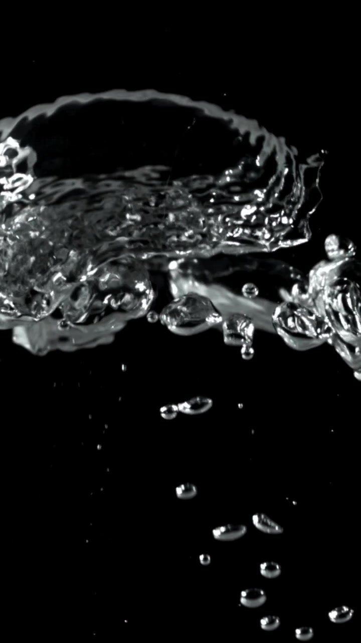 Clear Water Bubbles Rising in Slow Motion Against Black