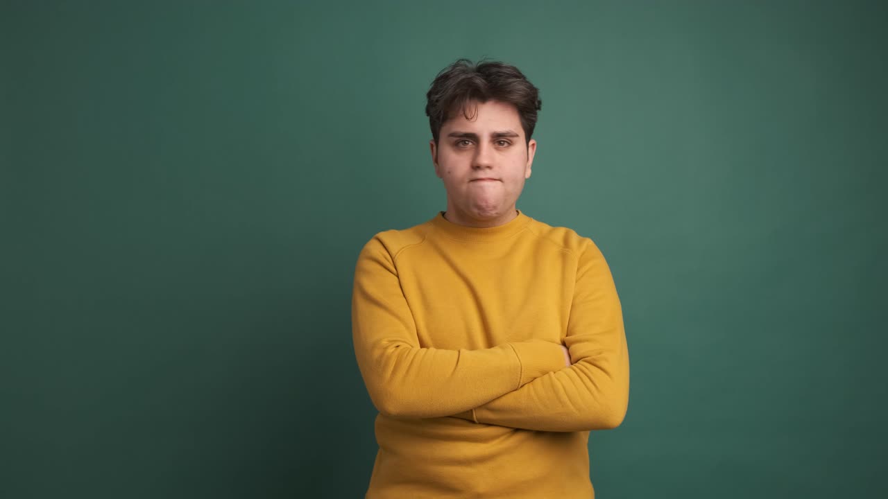 Sad and angry man standing with arms crossed looking around
