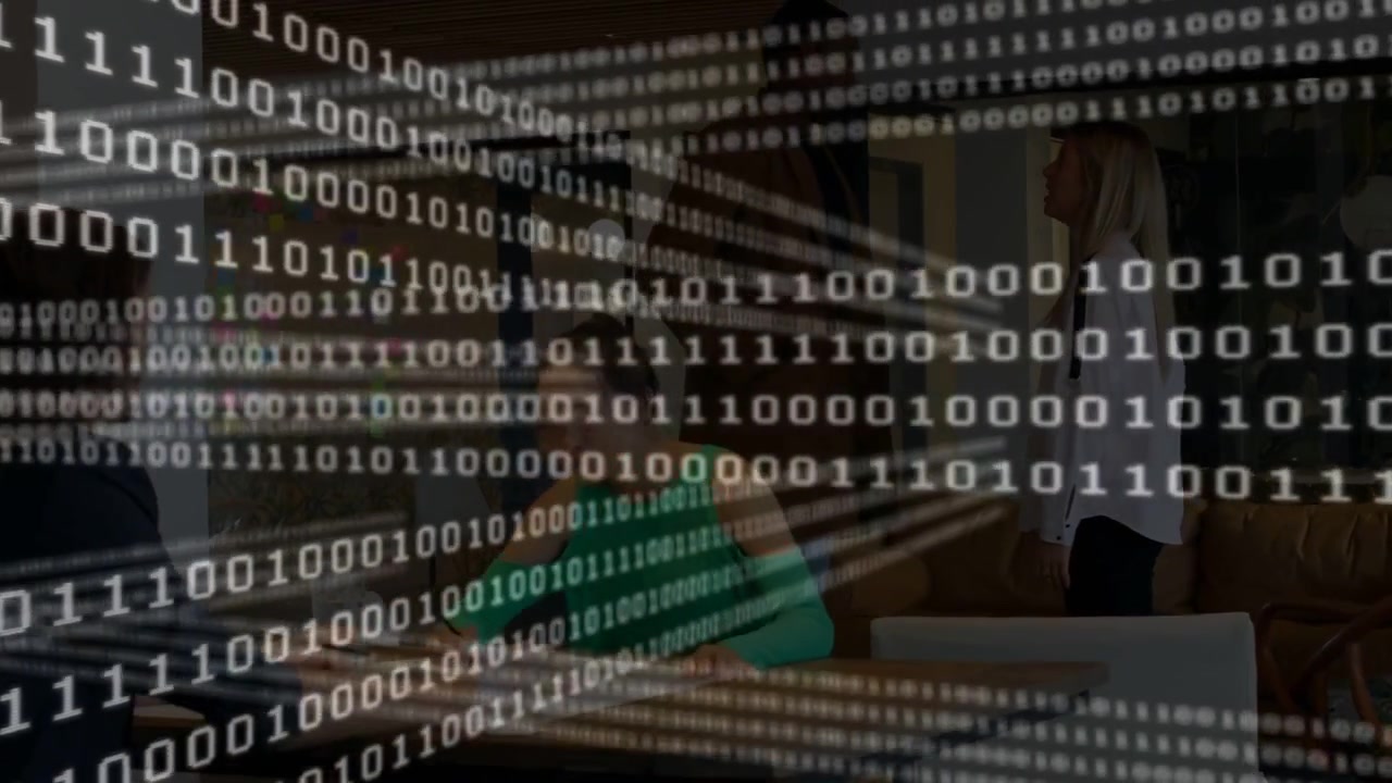 Seated worker using laptop while binary stream clearing, revealing standing peer for tech work