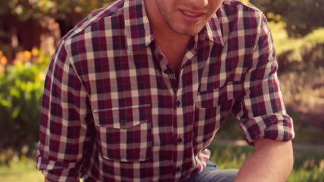 happy handsome gardener looking at camera