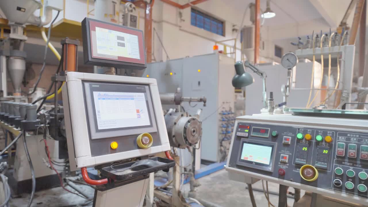 A detailed view of control panels within an industrial factory. The image showcases technology and equipment used in modern manufacturing processes, highlighting precision and innovation.