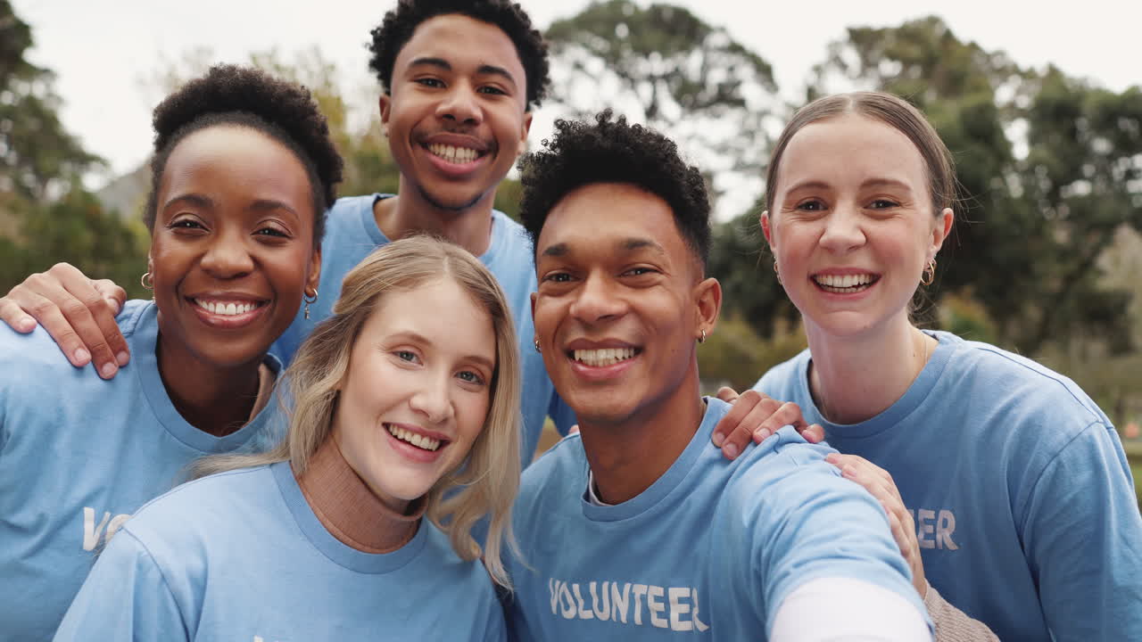Group of Volunteers Smiling and Making Heart Shapes with Their Hands