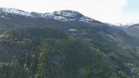 harastolen abandoned and discontinued tuberculosis sanatorium seen far away in the distant woods and mountainside - luster sogn norway aerial