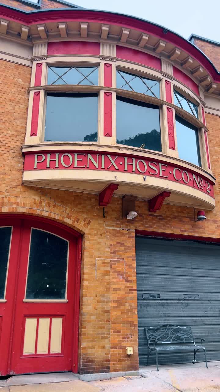 Jim Thorpe, USA, 2 July 2025: Exterior of Phoenix Hose Co No 2 firehouse. Close-up of a brick building facade with "Phoenix Hose Co No 2" text above a red door