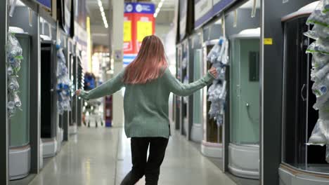 Woman-funny-dances-in-hardware-store-between-the-rows