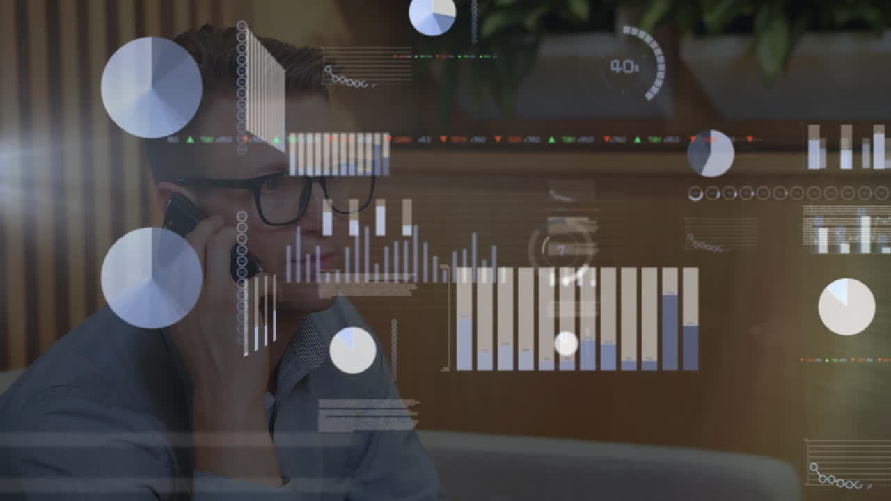 Animation of statistical data processing against caucasian man talking on smartphone at office