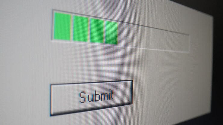 Mouse cursor clicks on a submit button and a green loading bar appears