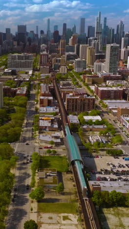 beautiful scenic picture of modern chicago on sunny daytime. drone descending over the underground railways. skyscrapers at backdrop. vertical video